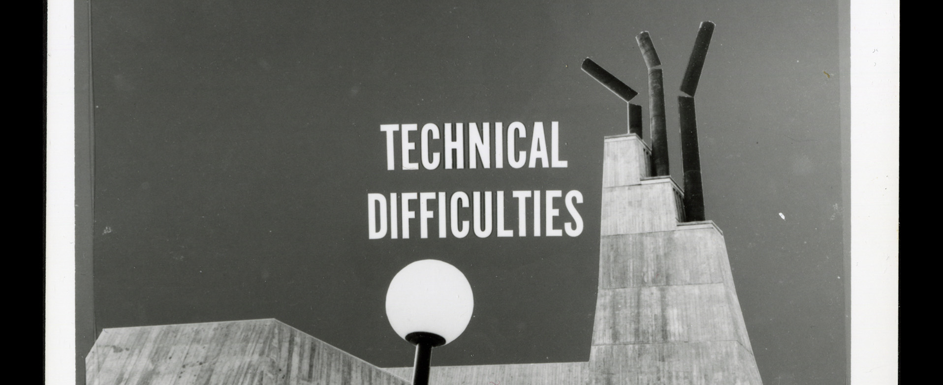 An edited image of the Humanities Wing smokestacks, broken with the text Technical Difficulties overlayed.